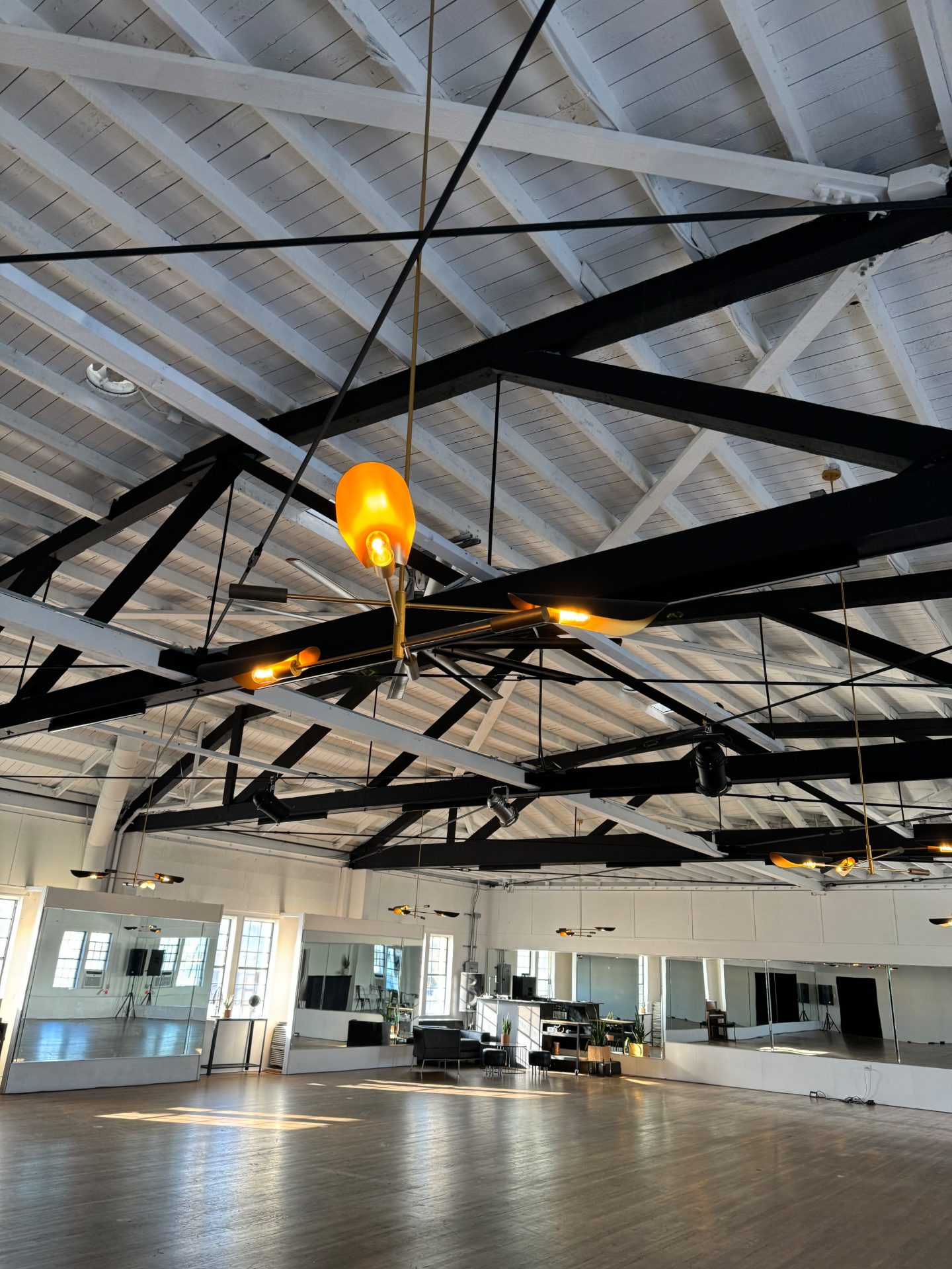 Open ballroom with exposed trusses and pendant lighting